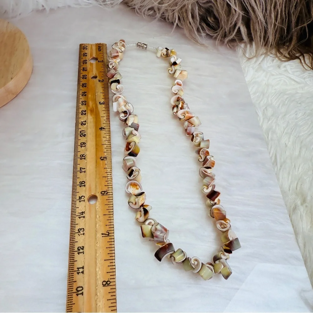 Beautiful vintage necklace composed of curly-cut conch shell beads individually